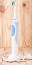 Electric Toothbrush on a light wooden background Royalty Free Stock Photo