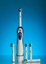 Electric toothbrush and replaceable nozzles of different colors Royalty Free Stock Photo