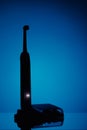 Electric toothbrush silhouette, blue background