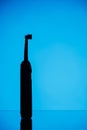 Electric toothbrush silhouette, blue background