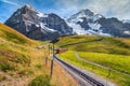 Electric tourist train and high snowy mountains with glaciers, Switzerland Royalty Free Stock Photo