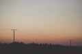 Electric tower cable nature landscape trees energy industry sunset mist Royalty Free Stock Photo