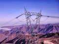 Electric tower on a 440 kv electric transmission line in arid and desert mountains Royalty Free Stock Photo
