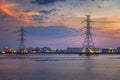 Electric towers and refinary oil storage plant in twilight Royalty Free Stock Photo