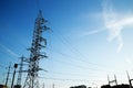 Electric poles and wires against a background of blue sky clouds