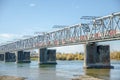 The electric train crosses the Ob river. Transsiberian railway. Autumn