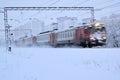 Electric train goes on railway route. Train transports passengers. Winter travel trip. Russia