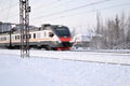 Electric train goes on railway route. Train transports passengers. Winter travel trip. Russia