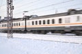 Electric train goes on railway route. Train transports passengers. Winter travel trip. Russia