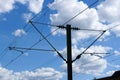 Electric train lines railway electrification overhead system with wires and blue sky above Royalty Free Stock Photo