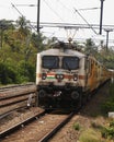 electric train moving through the indian railway track Royalty Free Stock Photo