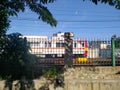 Electric train passing inside the fence Royalty Free Stock Photo