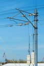 Electric train railway line tension pole with wires and concrete weights