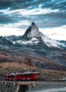 Electric train running on railway through Matterhorn mountain in Gornergrat station Royalty Free Stock Photo