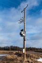 Electric transformers and wires installed on wooden column. Low voltage wires to supply power to the user Royalty Free Stock Photo