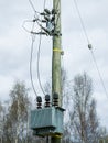 Electric transformers and wires installed on wooden column. Low voltage wires to supply power to the user Royalty Free Stock Photo