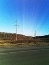 Electric transmission line. Power transmission pylon silhouette against blue sky at dusk. The concept of electrification Royalty Free Stock Photo