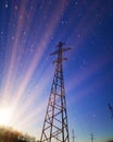 Electric transmission line. Power transmission pylon silhouette against blue sky at dusk. The concept of electrification Royalty Free Stock Photo