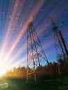 Electric transmission line. Power transmission pylon silhouette against blue sky at dusk. The concept of electrification Royalty Free Stock Photo