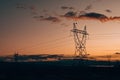 Electric transmission lines against a background of sunset over mountains Royalty Free Stock Photo