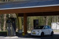 Charging a Fiat 500E with electricity at a public charging station in the Netherlands