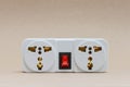 Electric travel outlet with red button switch with the brown background Royalty Free Stock Photo