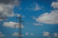 Electric trellis with a cloudy blue sky in the background.