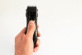 Electric trimmer in a hand on a white background Royalty Free Stock Photo
