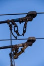 Electric trolleybus collectors close-up against the April blue spring sky. Power line wires network. Public transport. Royalty Free Stock Photo