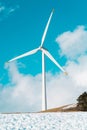 Electric Turbine Windmill on a blue sky. Closeup image of turbines blades on a snowy ground Royalty Free Stock Photo
