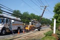 Electric utility repair crew on the scene of a broken wooden utility pole