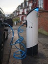 An electric vehicle being charged at a charging station at a residential street in London, UK