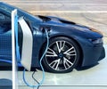 Electric vehicle being plugged in Royalty Free Stock Photo