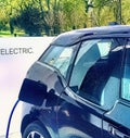 Electric vehicle being plugged in Royalty Free Stock Photo