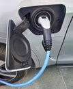 Electric vehicle being plugged in Royalty Free Stock Photo