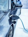 Electric vehicle being plugged in Royalty Free Stock Photo