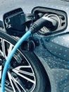 Electric vehicle being plugged in Royalty Free Stock Photo