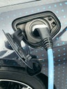 Electric vehicle being plugged in Royalty Free Stock Photo