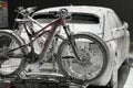 Electric vehicle and bicycles at self-service car wash during nighttime, covered in foam, Royalty Free Stock Photo