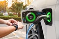 Electric vehicle changing on street parking with graphical user interface synchronize with smart watch, Future EV car concept Royalty Free Stock Photo