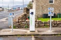 Electric vehicle charging station along a street in a coastal town in Scotland