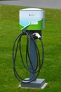 Electric car charging point installed on green lawn