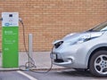 Electric Vehicle `EV` charging electric power at public charge point.