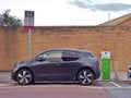 Electric Vehicle `EV` charging electric power at public charge point.