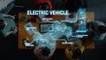 Electric Vehicle Overview with Smart Battery System and Electric Components Explored by Group of People Collaborating in Royalty Free Stock Photo