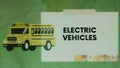 Electric Vehicles inscription on green background with yellow bus illustration. Graphic presentation. Transportation