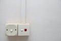 An electric wall socket on off switch without light on indicator and another with red light power on indicator Royalty Free Stock Photo