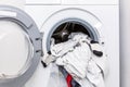 Electric washer with clothes inside in the laundry room Royalty Free Stock Photo