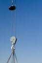 Electric winch hook lifts load on cables at the construction site