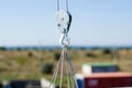 Electric winch hook lifts load on cables at the construction site